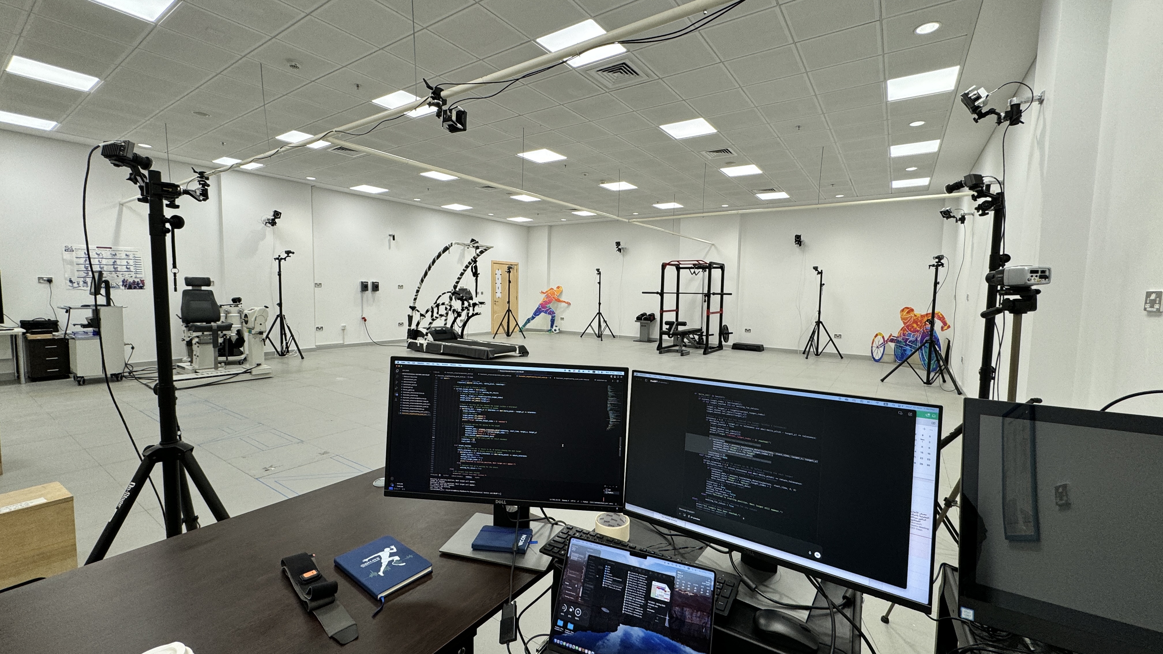 A high-tech motion capture lab equipped with multiple cameras mounted on tripods along the walls and ceiling